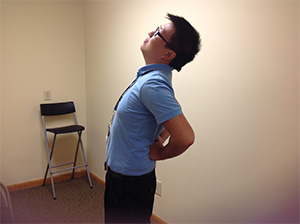 Hmong man experiencing back pain